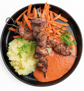 Grilled pork skewers with Chipotle carrots and roasted pepper sauce