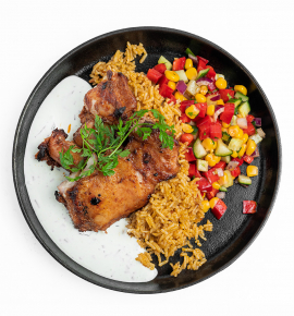 Grilled chicken with Mexican rice, corn salsa, and sour cream sauce